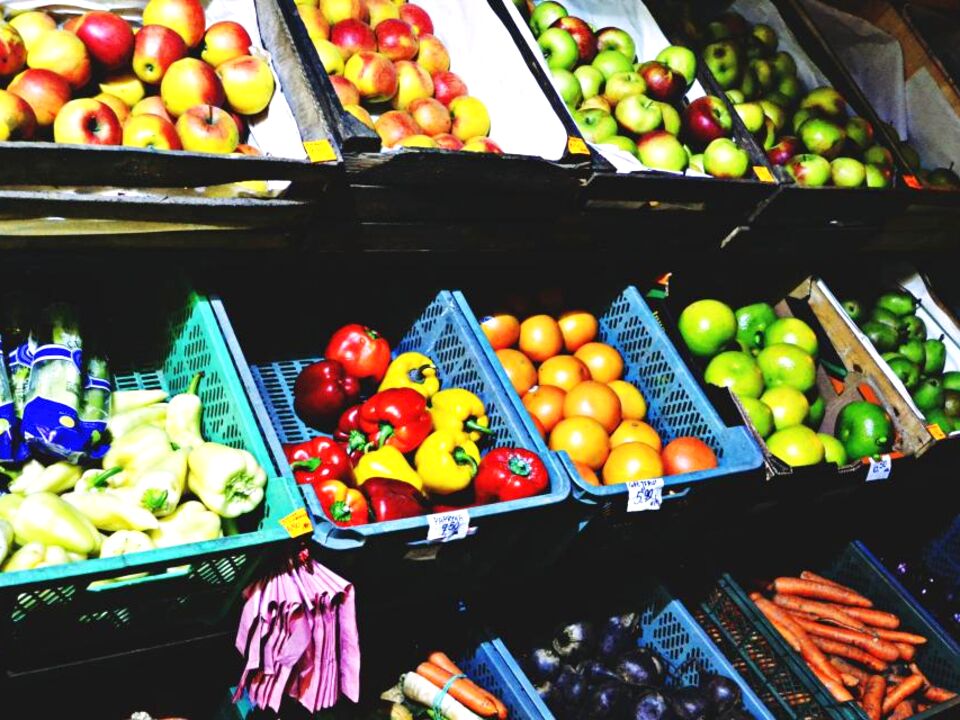 Colourful fruit and vegetables on market shelves