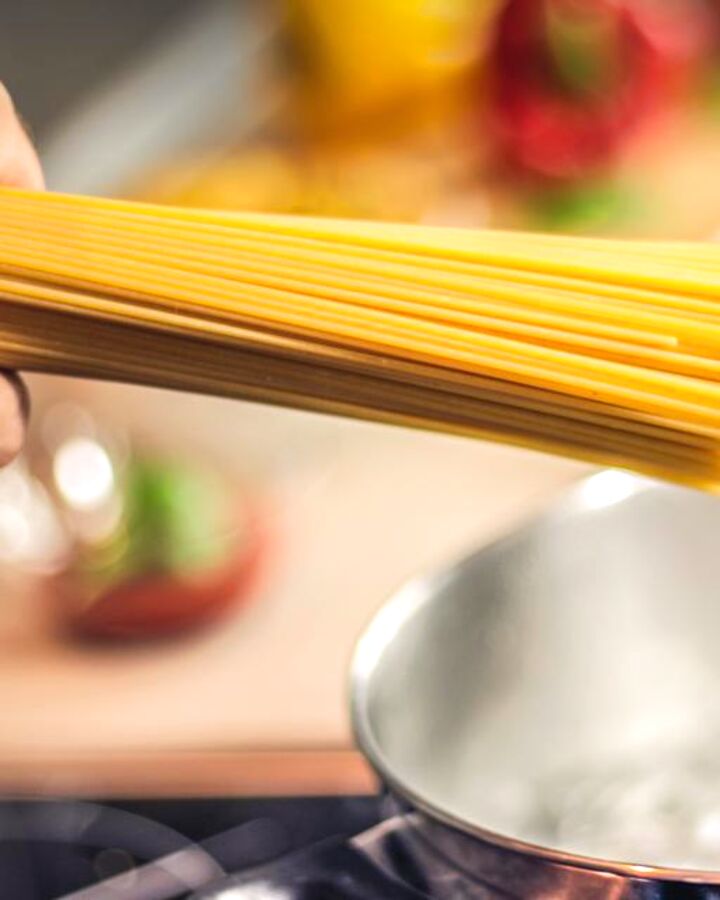 Pasta going into a pot on the stove